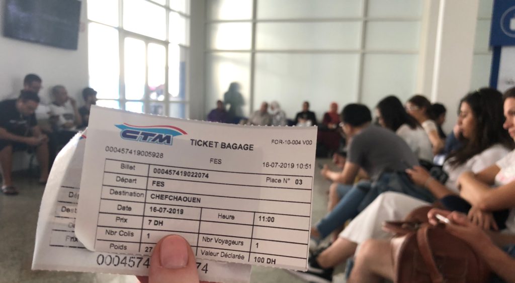 Printed Morocco bus ticket at a station counter